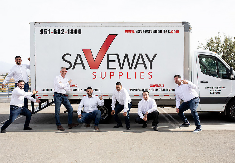 Saveway team posing playing next to delivery truck