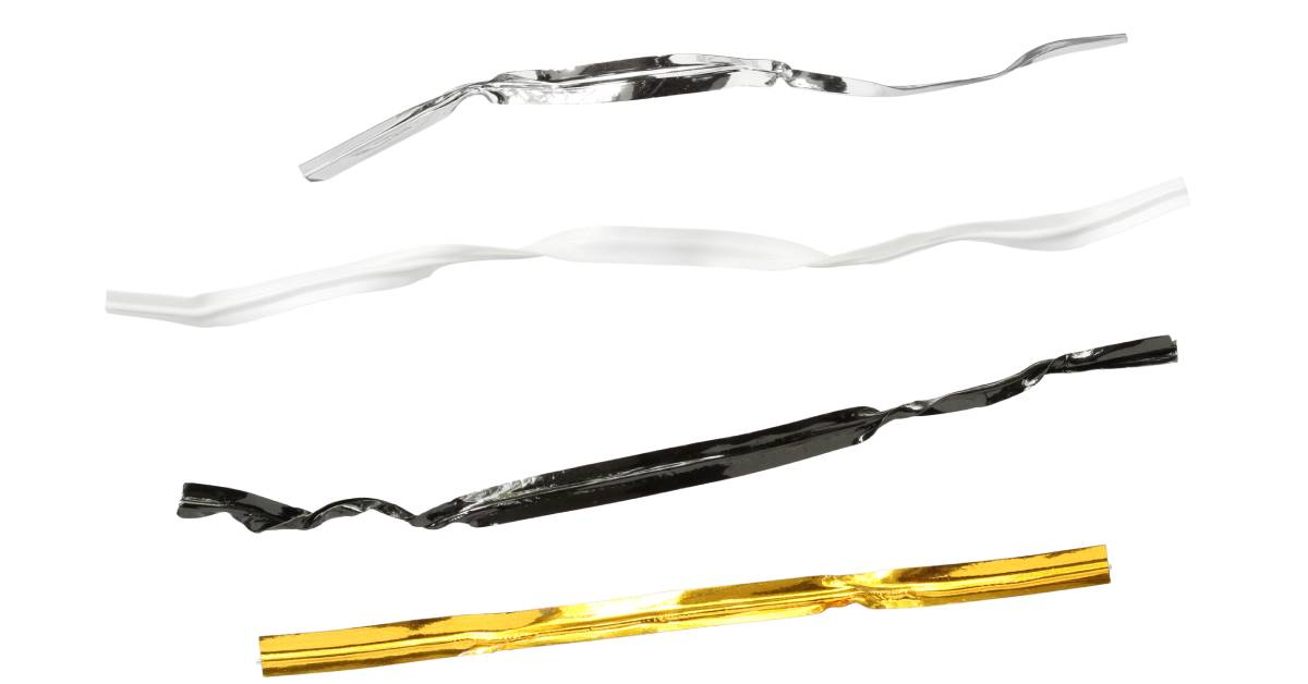 Against a white background, there are four different twist ties in silver, white, black, and gold.